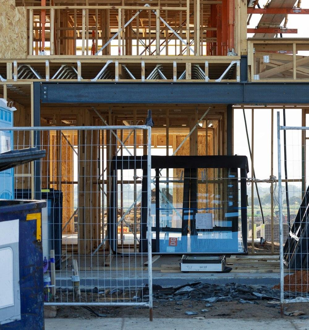 A residential construction site secured behind temporary fencing