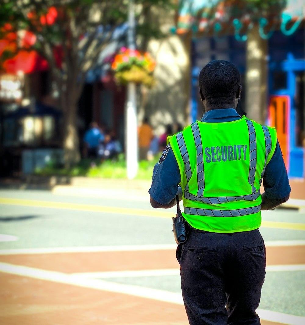 A security guard in a high-visibility vest on patrol